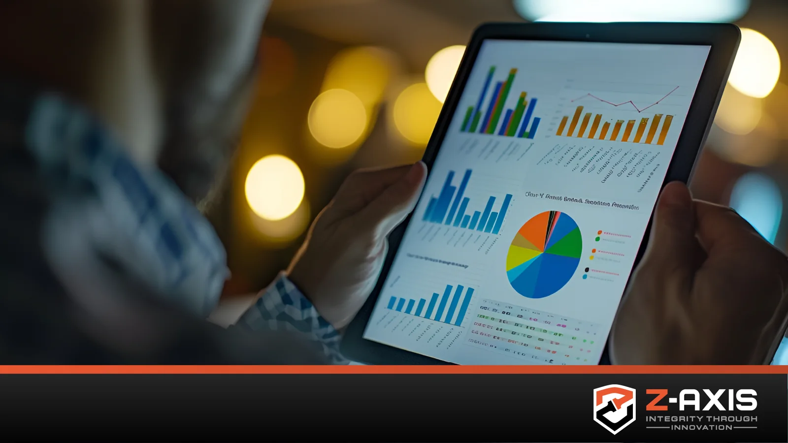 man holding tablet showing data graphs