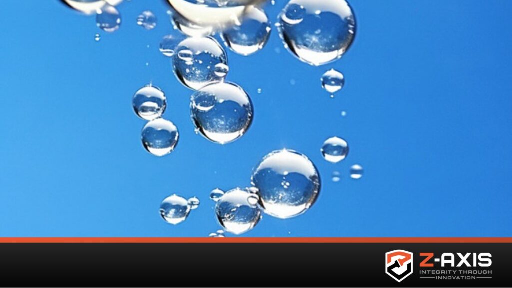 Water bubbles over blue background demonstrating dunk leak testing, with black banner across bottom of image with Zaxis logo