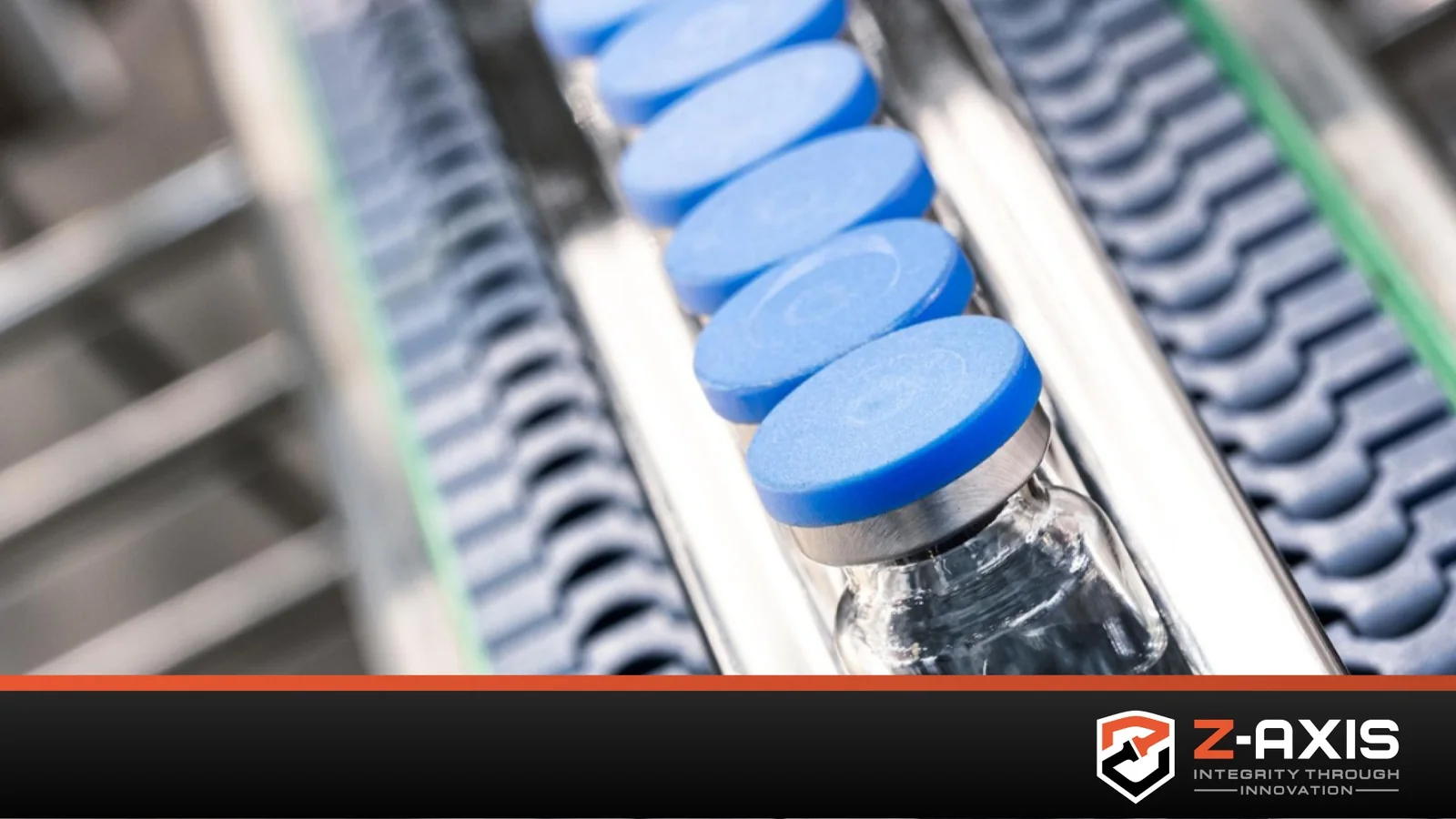 Clear vials / medicine bottles moving down a conveyor belt, demonstrating the important of leak testing in the pharmaceutical industry