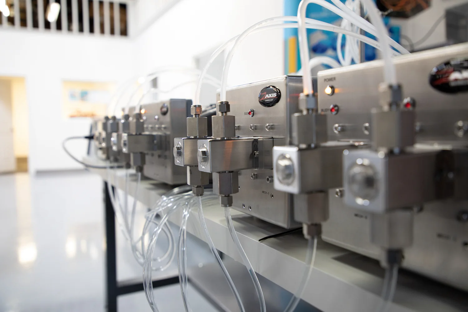 V series, positive displacement, rotating reciprocating metering pumps by Zaxis in a line on a table