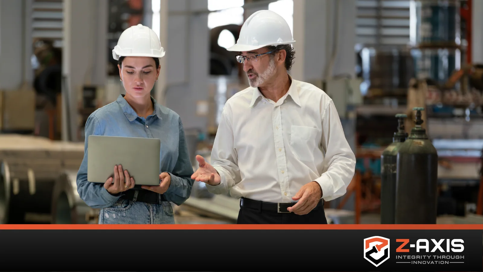 man and woman wearing white construction hard hats discussing something