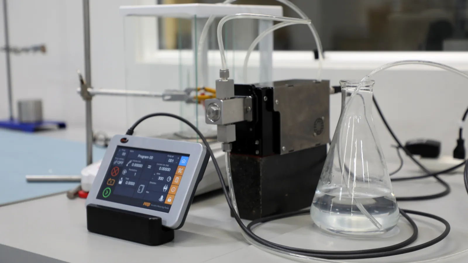Zaxis eVmP metering pump with TSi controller dispensing into lab glassware