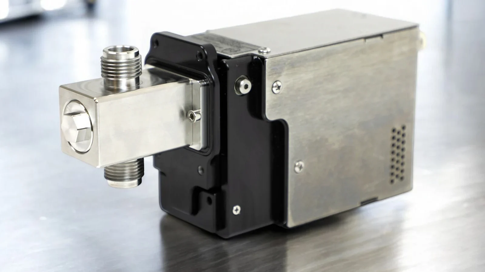 V-Series ceramic pump head and stepper drive on a stainless bench in a pharmaceutical cleanroom