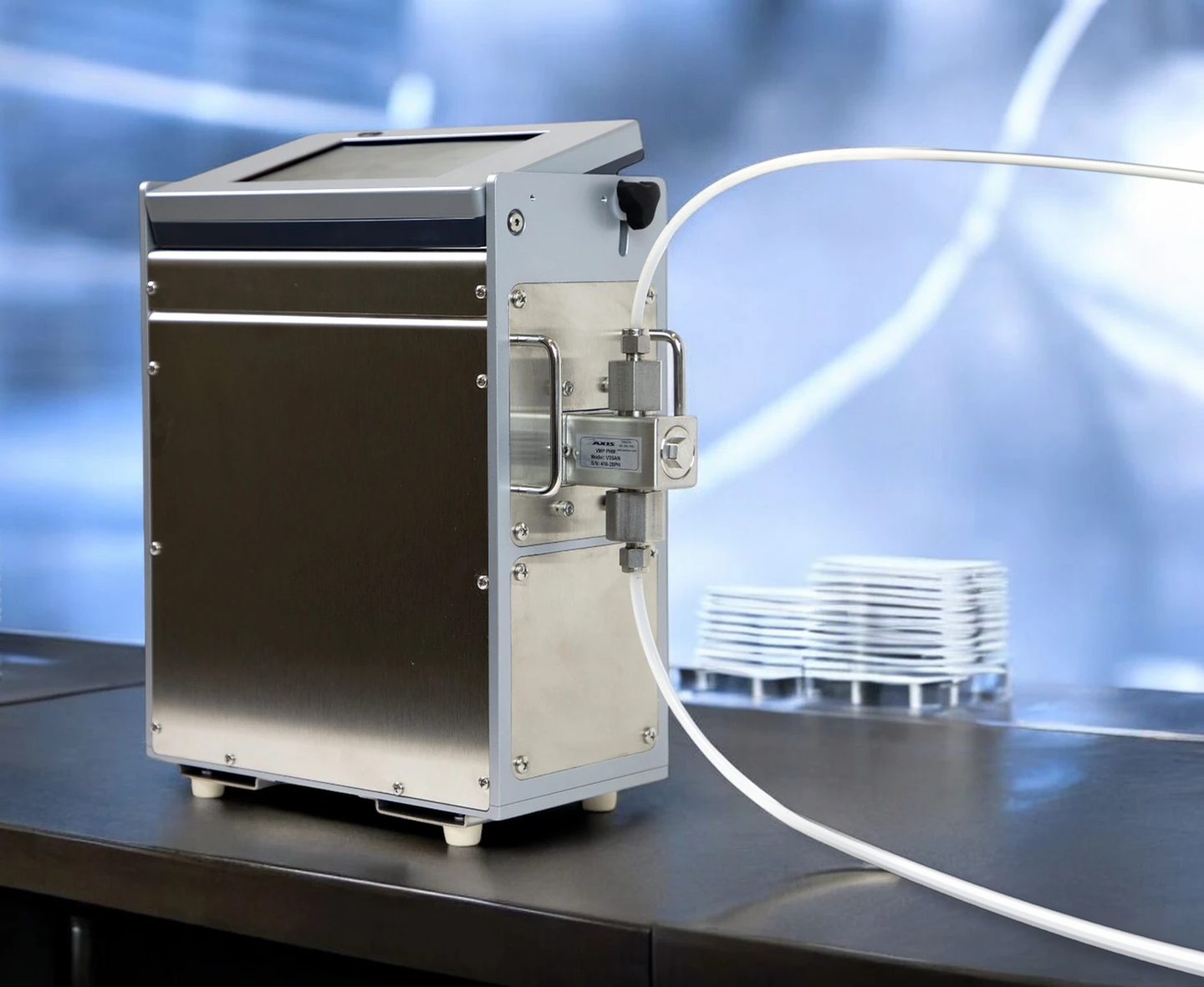 Zaxis eVmP1 benchtop valveless metering pump with dispense tubing on a biotech laboratory bench